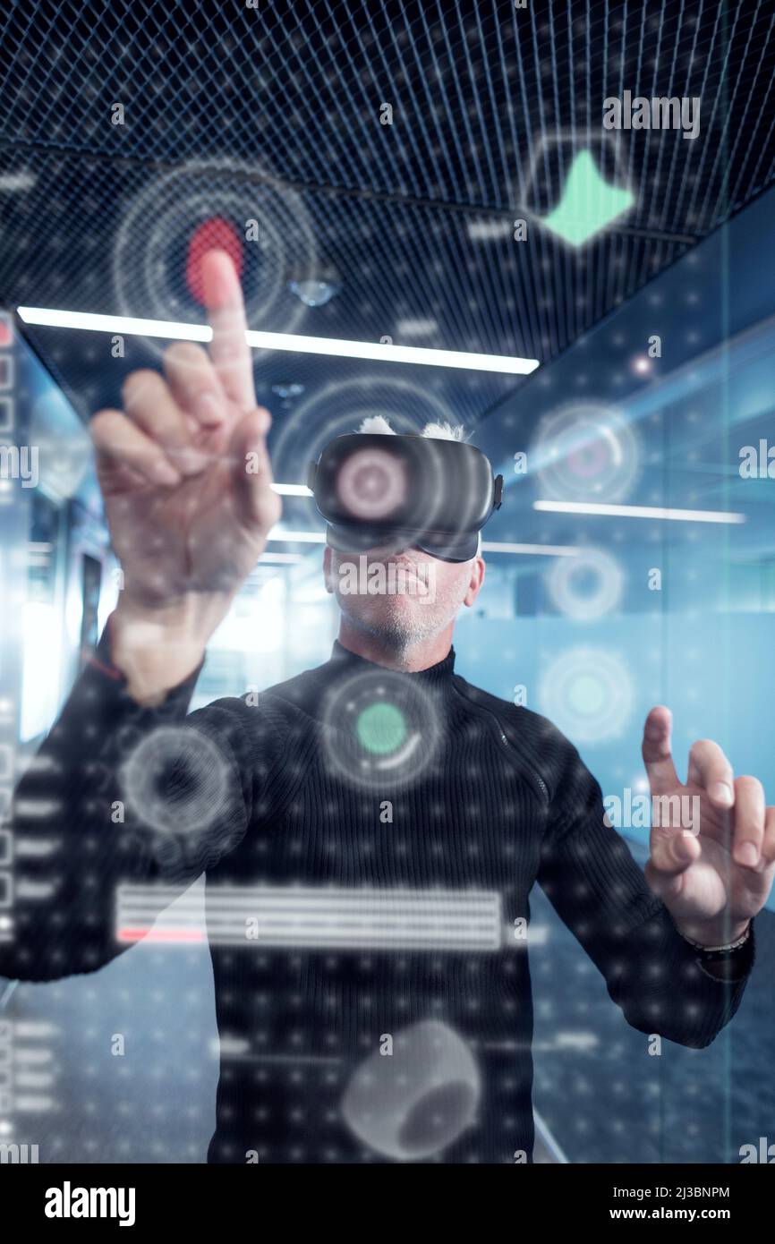 Senior man in virtual reality headset using advanced technology Stock Photo