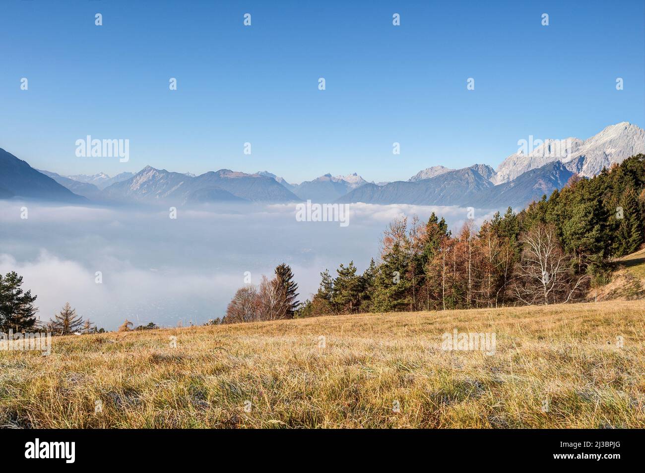 Hidden under the fog lies the town of Telfs in Tyrol, directly at the entrance to the Oberinntal. Stock Photo