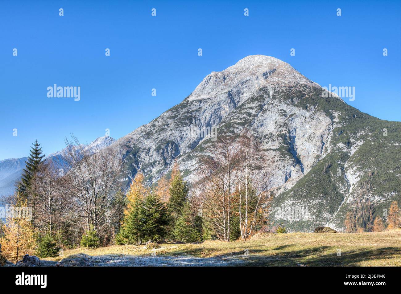 The Hohe Munde is a mighty mountain of unusual shape in the Tyrolean Wetterstein Mountains and rises hight 2662 meters north of the town of Telfs. Stock Photo