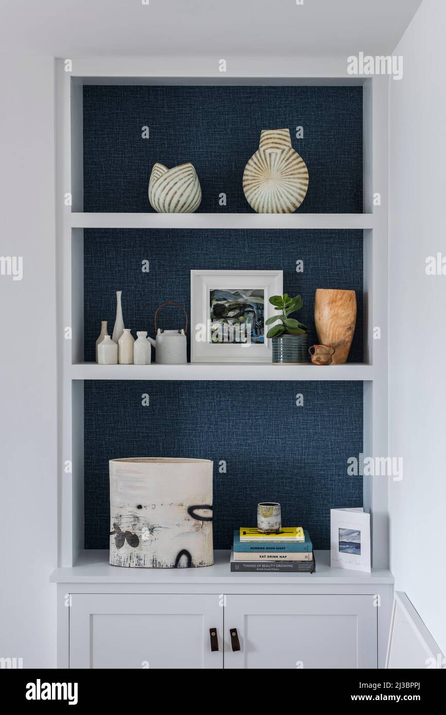 Ornaments and artwork on recessed shelves in renovated St Ives home, Cornwall, UK Stock Photo