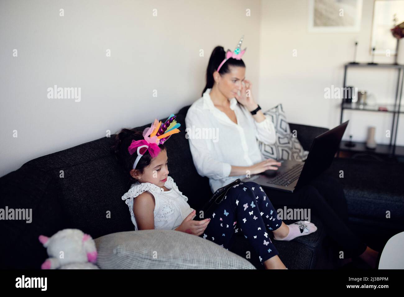 Mother and daughter on sofa Stock Photo
