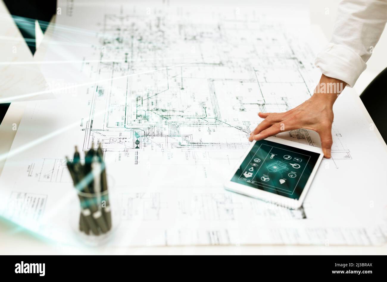Architect using digital tablet on whiteprint Stock Photo