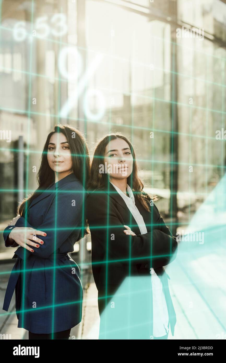 Portrait of young businesswomen in front of office Stock Photo