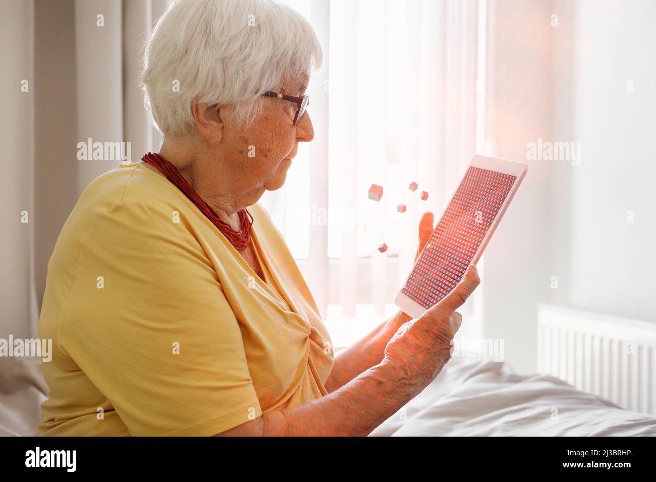 Senior woman using digital tablet Stock Photo
