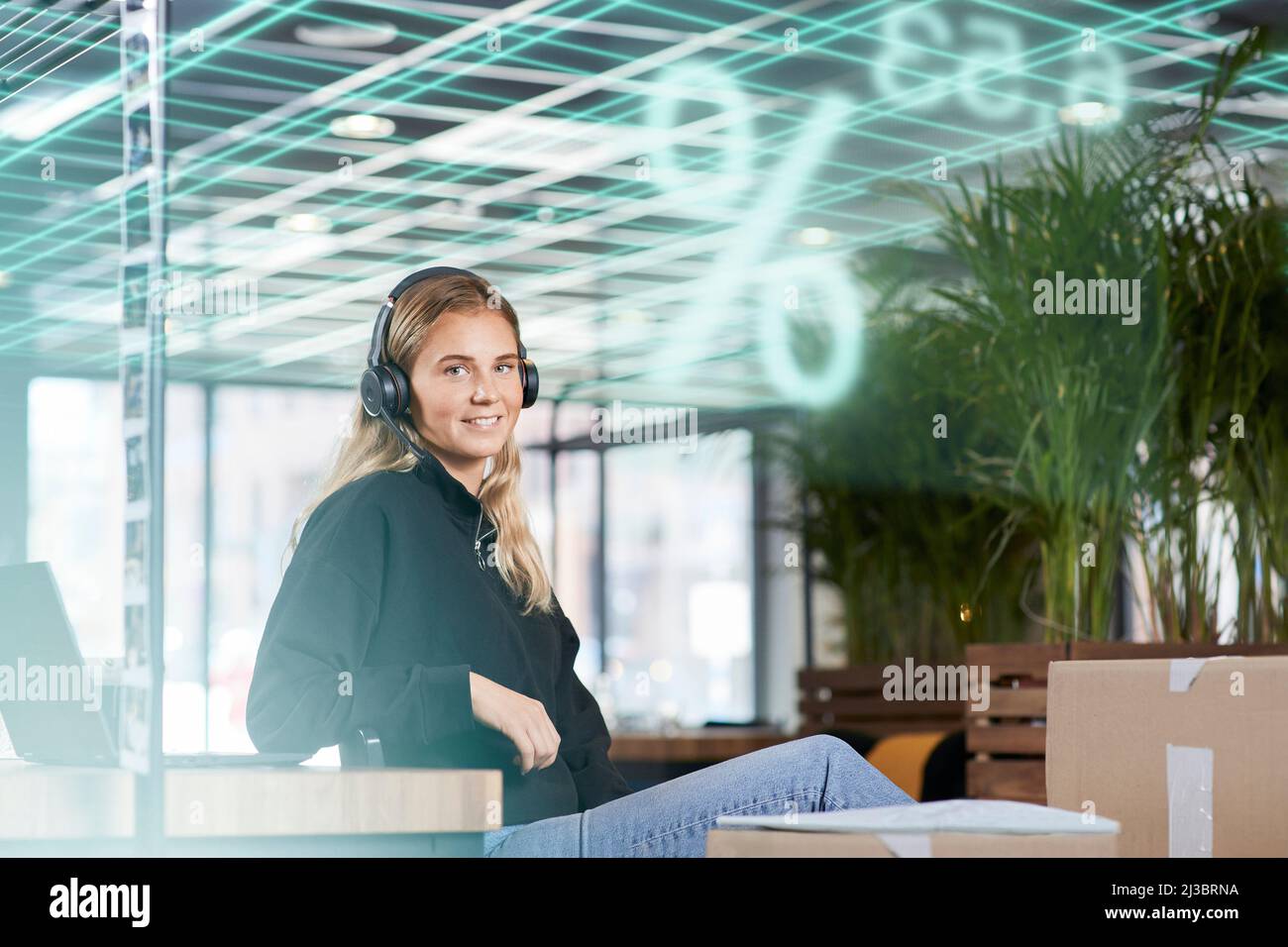 Portrait of smiling young businesswoman in headphones Stock Photo
