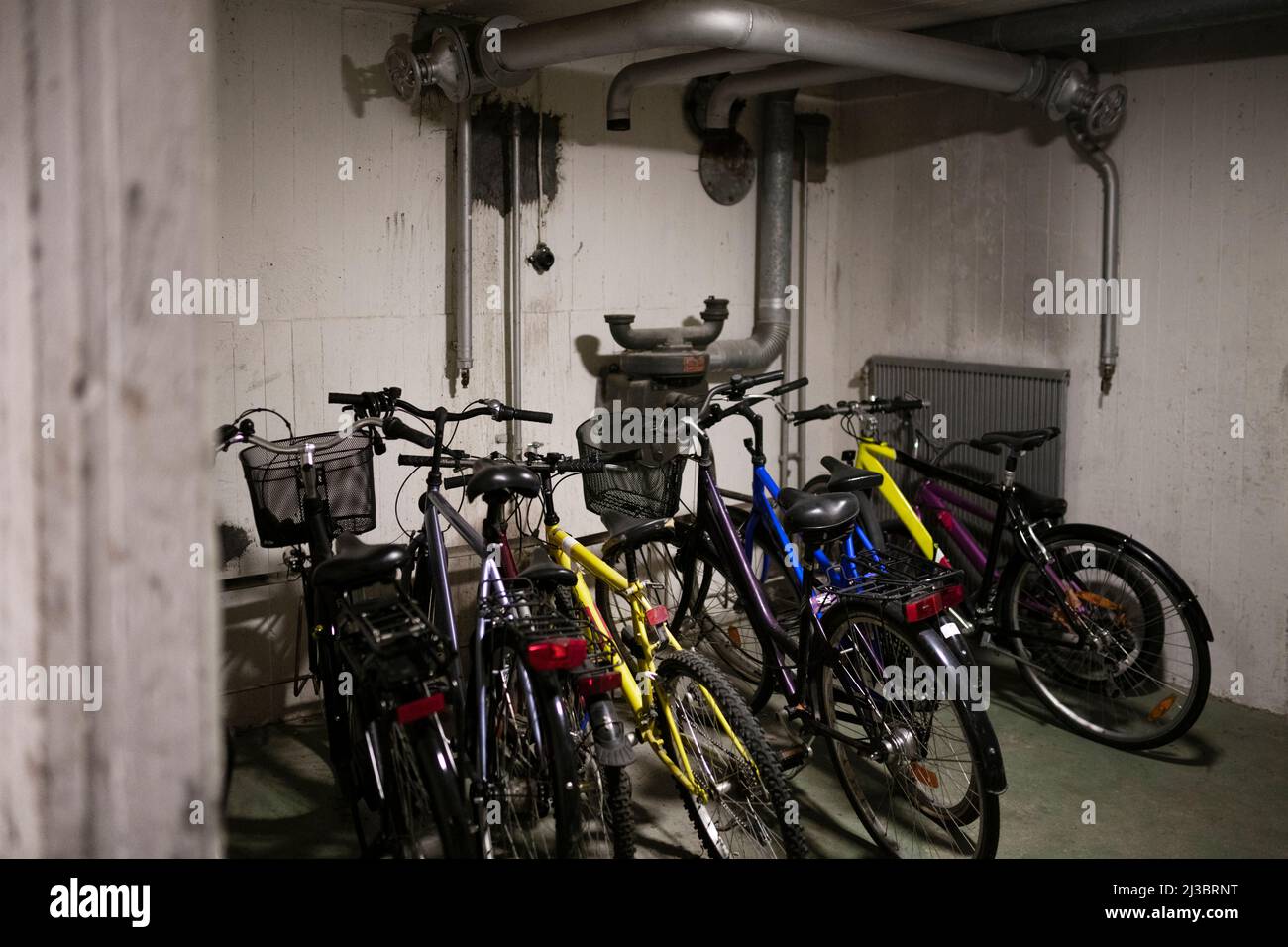 Bicycles parked in basement Stock Photo