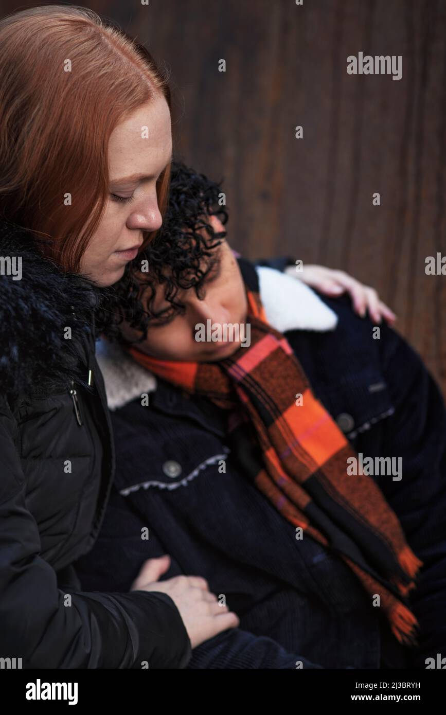 Young woman hugging and comforting boy Stock Photo