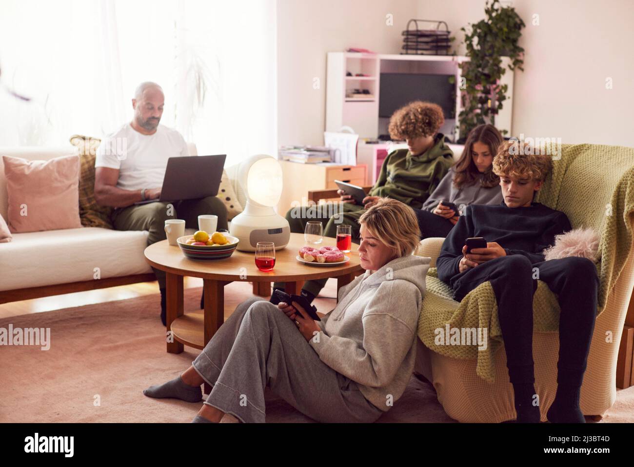 Family with children using electronic devices at home Stock Photo Alamy