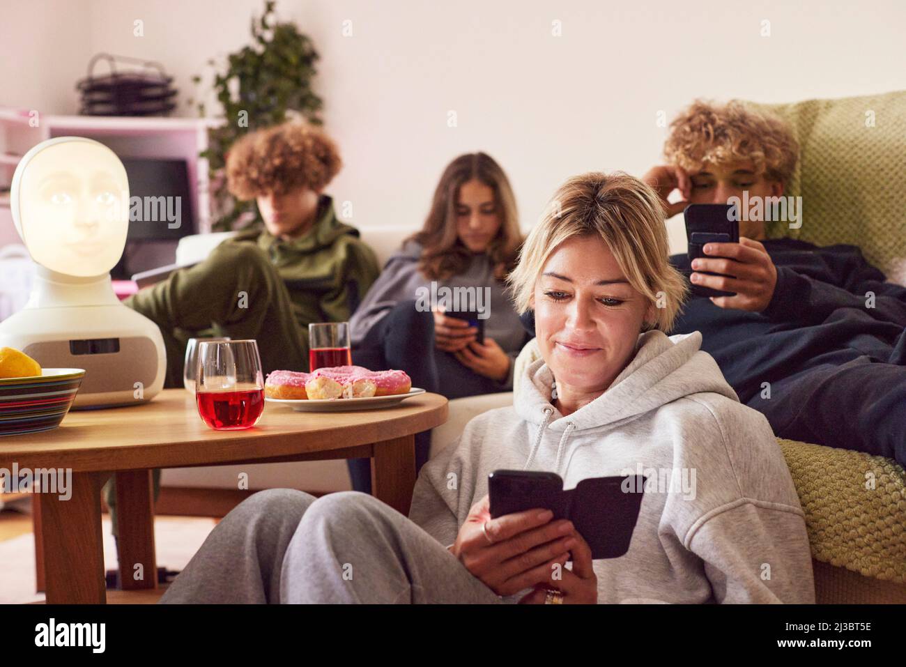 Mother with children using electronic devices at home Stock Photo
