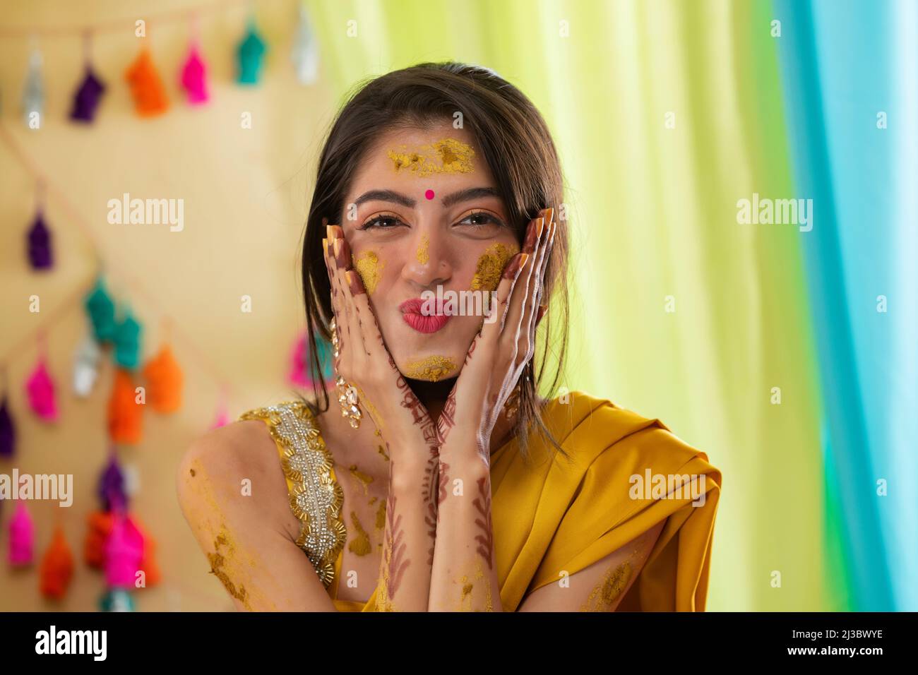 Close-up portrait of an Indian bride with turmeric applied on face Stock Photo