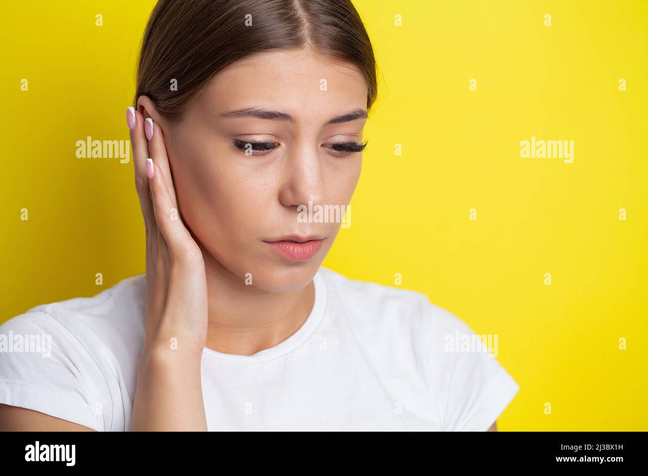 Closeup up side profile sick female having ear pain touching her