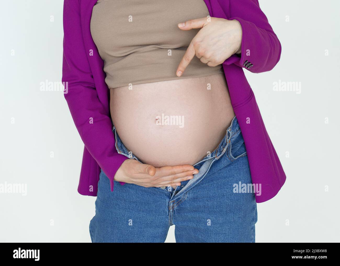 Close up, pregnant belly Pregnant Woman showing finger, unrecognizable pregnant woman expecting child, Young happy mother Stock Photo