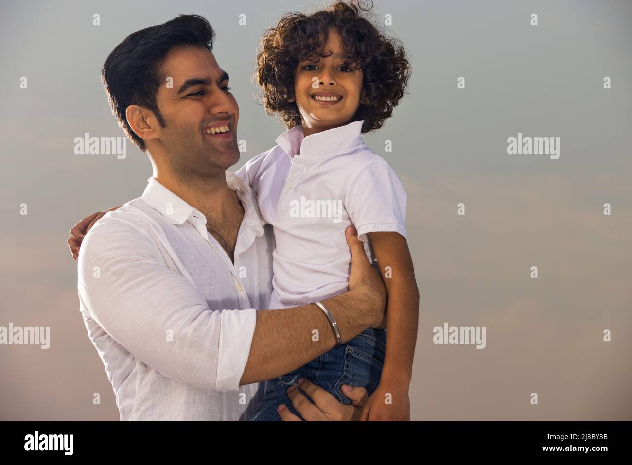 Indian father carrying son hi-res stock photography and images - Alamy