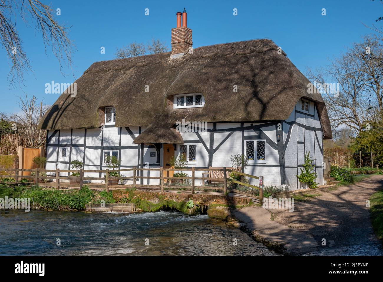 The Fulling Mill across the River Alre in Alresford Hampshire England Stock Photo