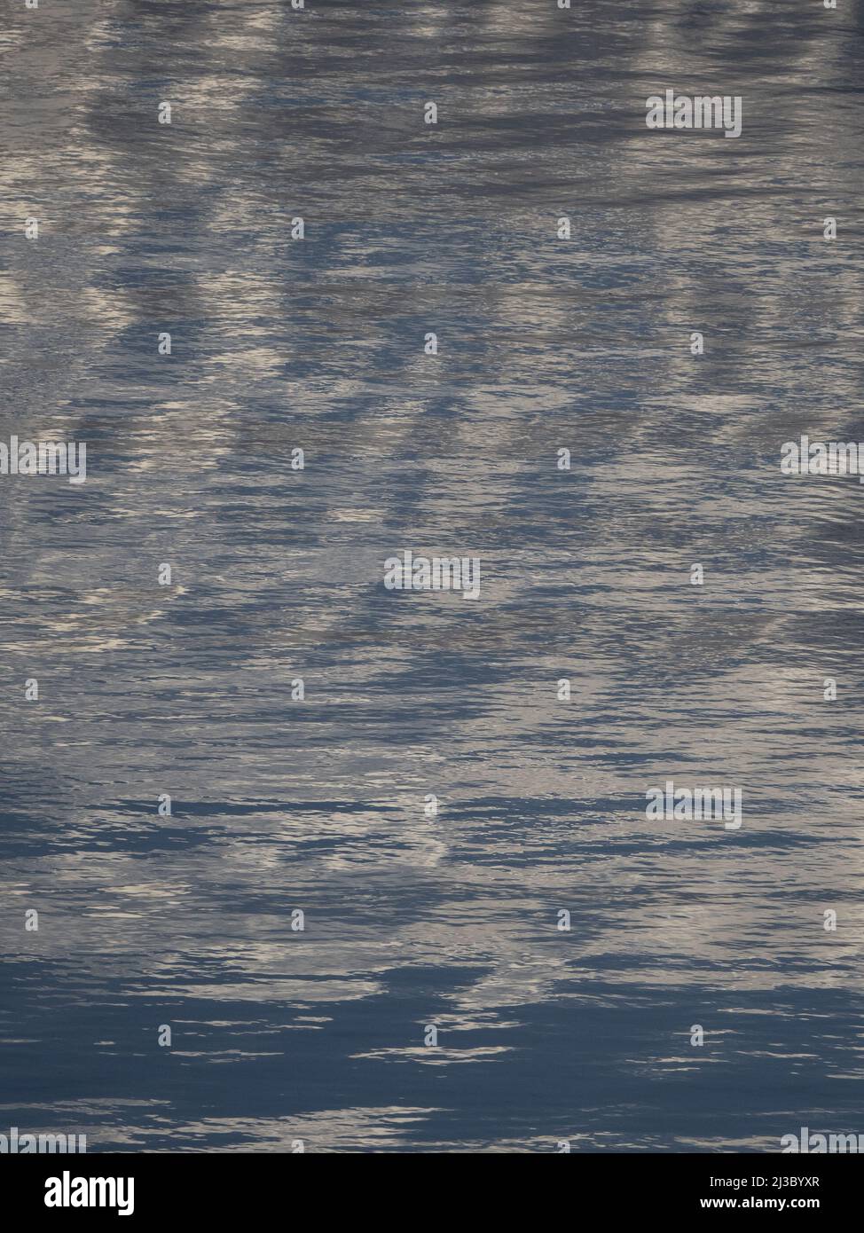 Abstract, shimmering blue pattern on distant Caribbean Sea at Dawn Stock Photo
