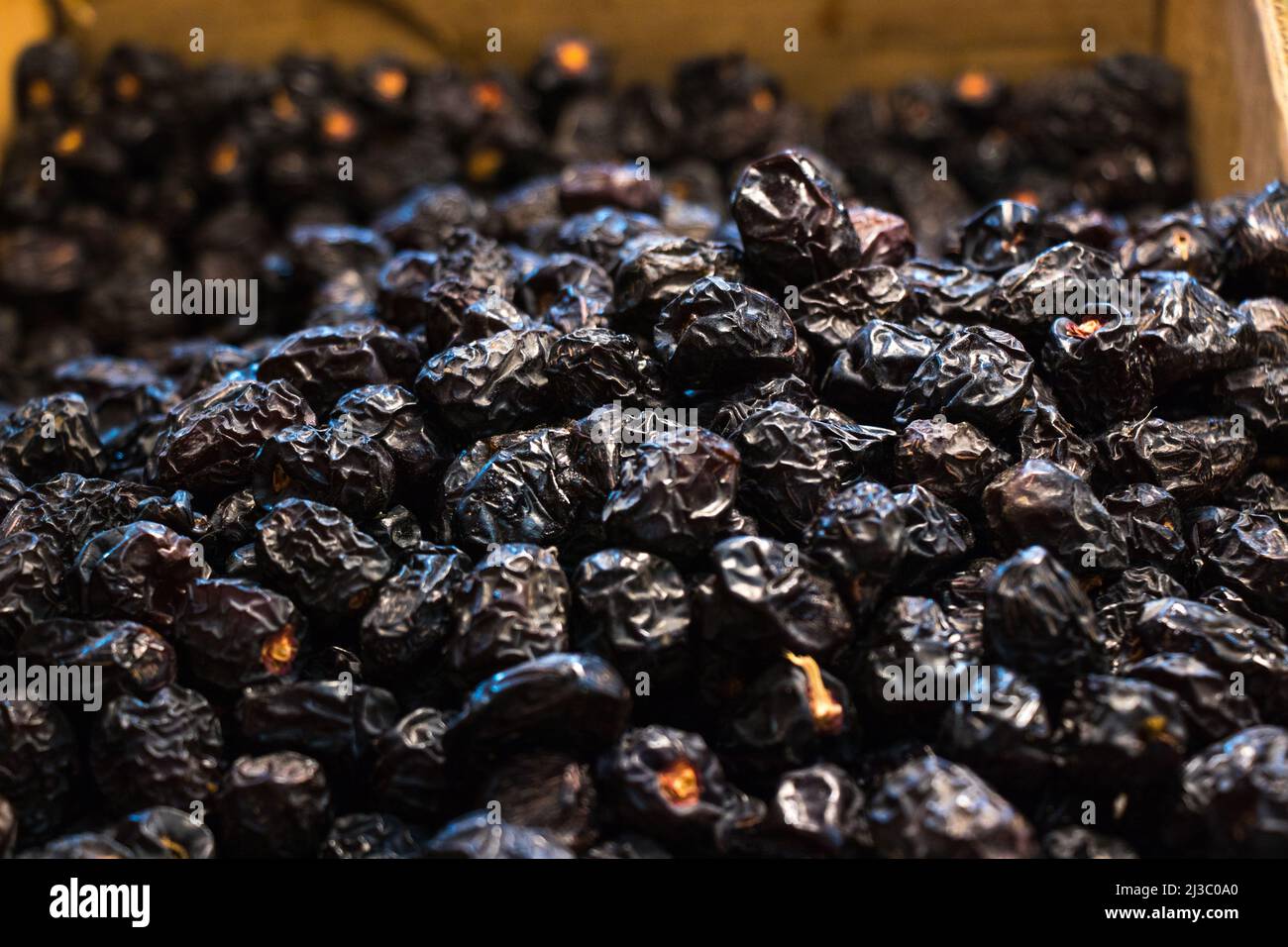 Ajwa dates. Dried dates, fruits of date palm. Fruit market selling ajwa dates for iftar Stock