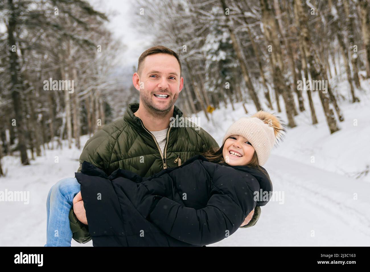 Handsome dad and his daughter are having fun outdoor in winter Stock ...