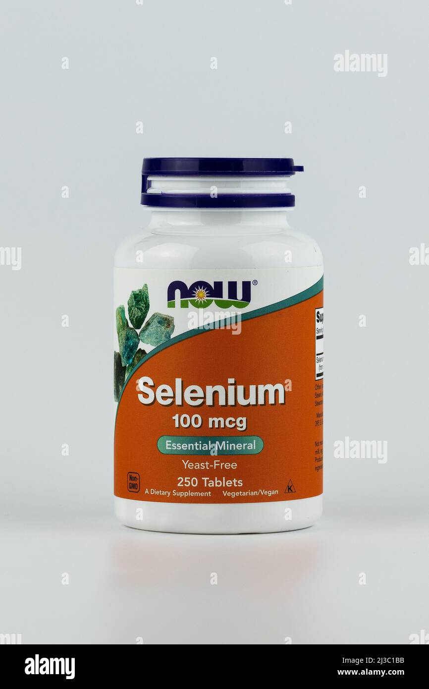 Selenium tablets in the jar. dietary supplement vertical editorial