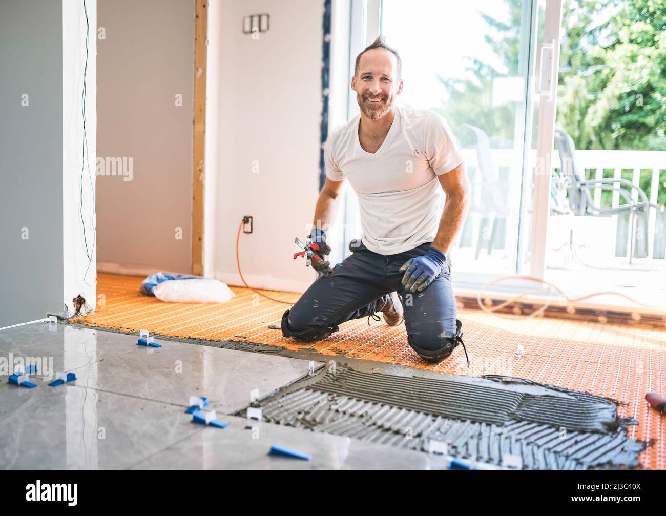 nice handyman install tile on the floor Stock Photo Alamy