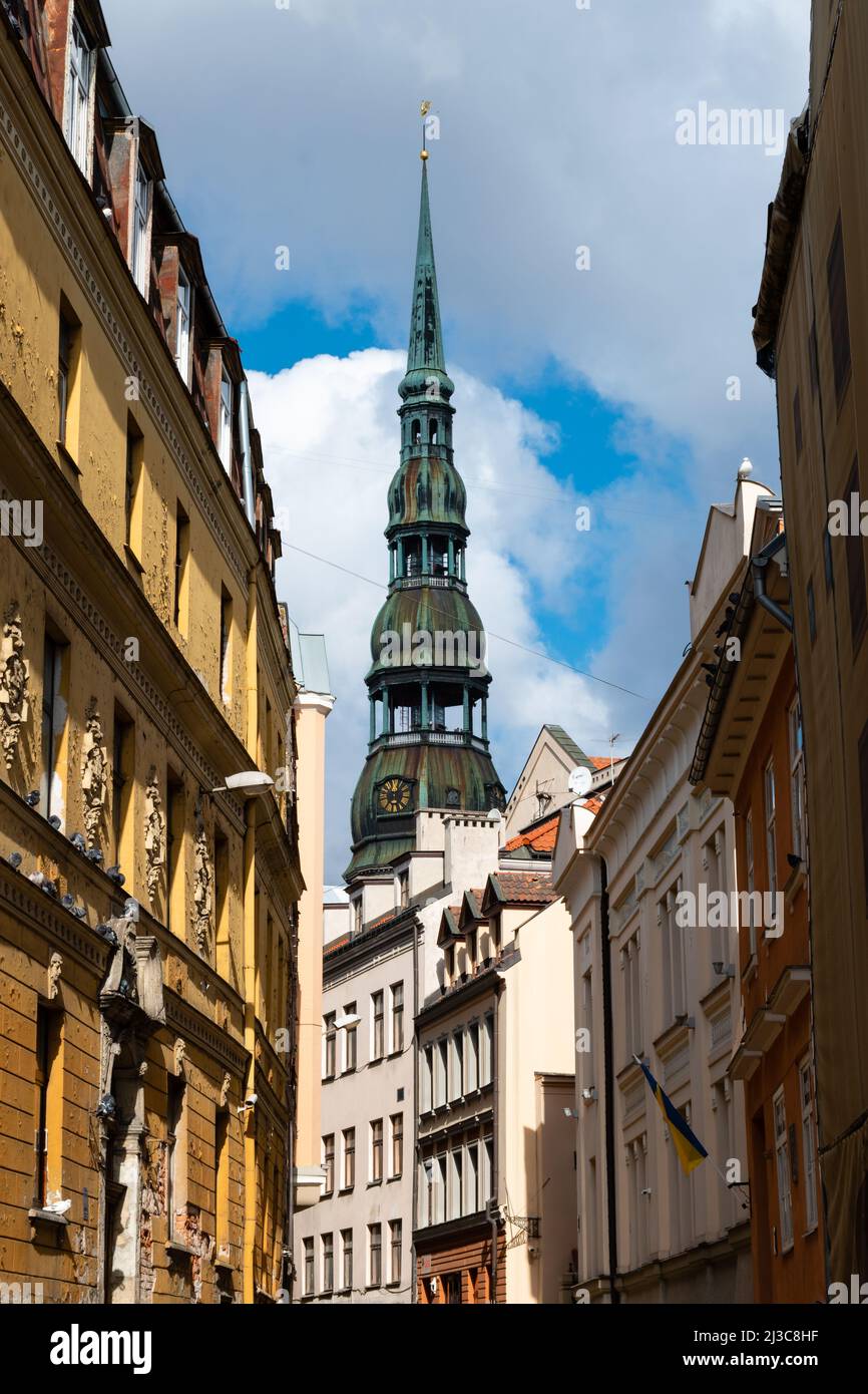 The steeple of the St. Peter's Church behind colourful buildings in ...