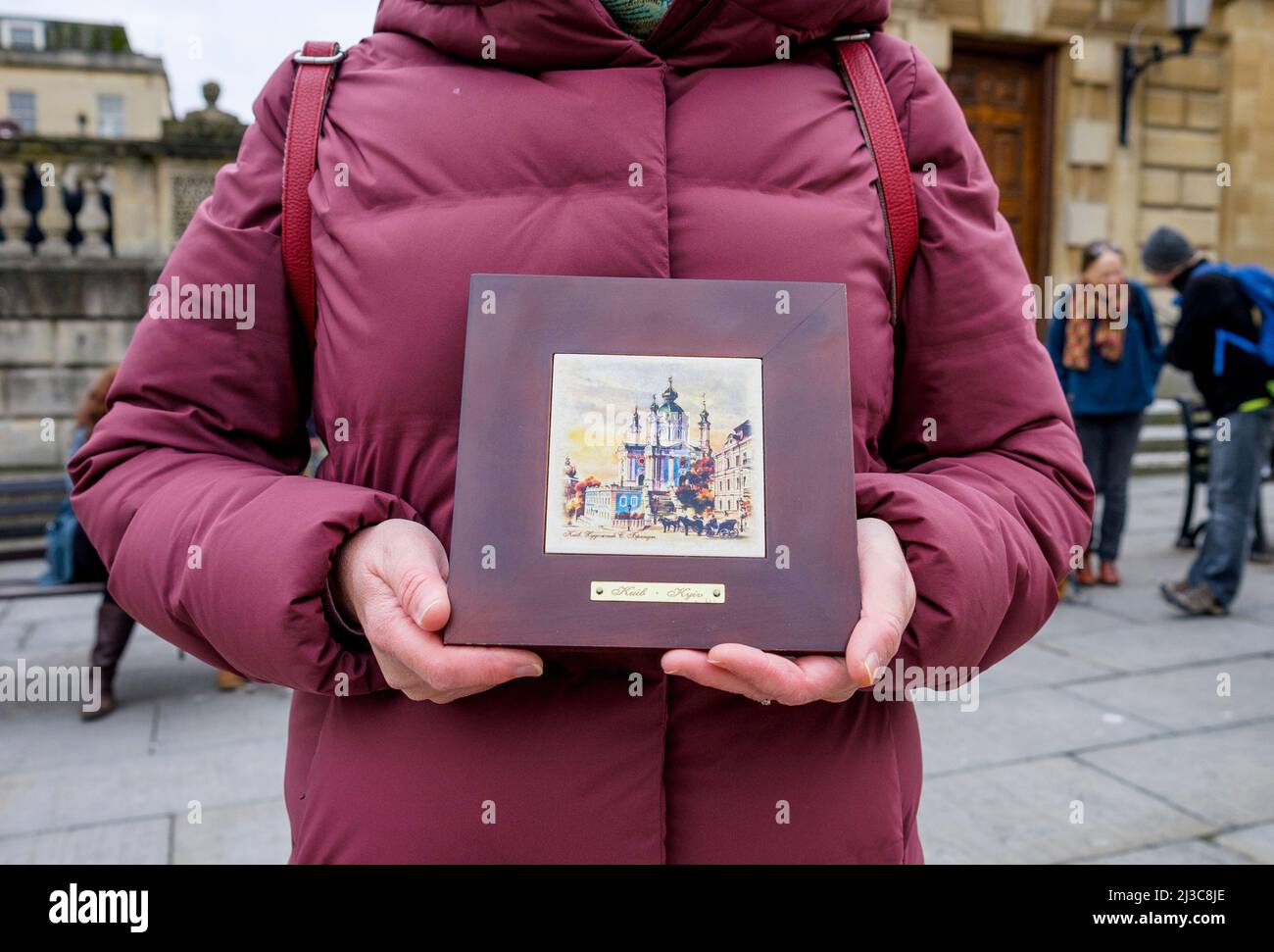 A woman in front of Bath Abbey holds up a drawing of Kyiv as she takes part in a demonstration against Russia's invasion of Ukraine. 26th March, 2022 Stock Photo