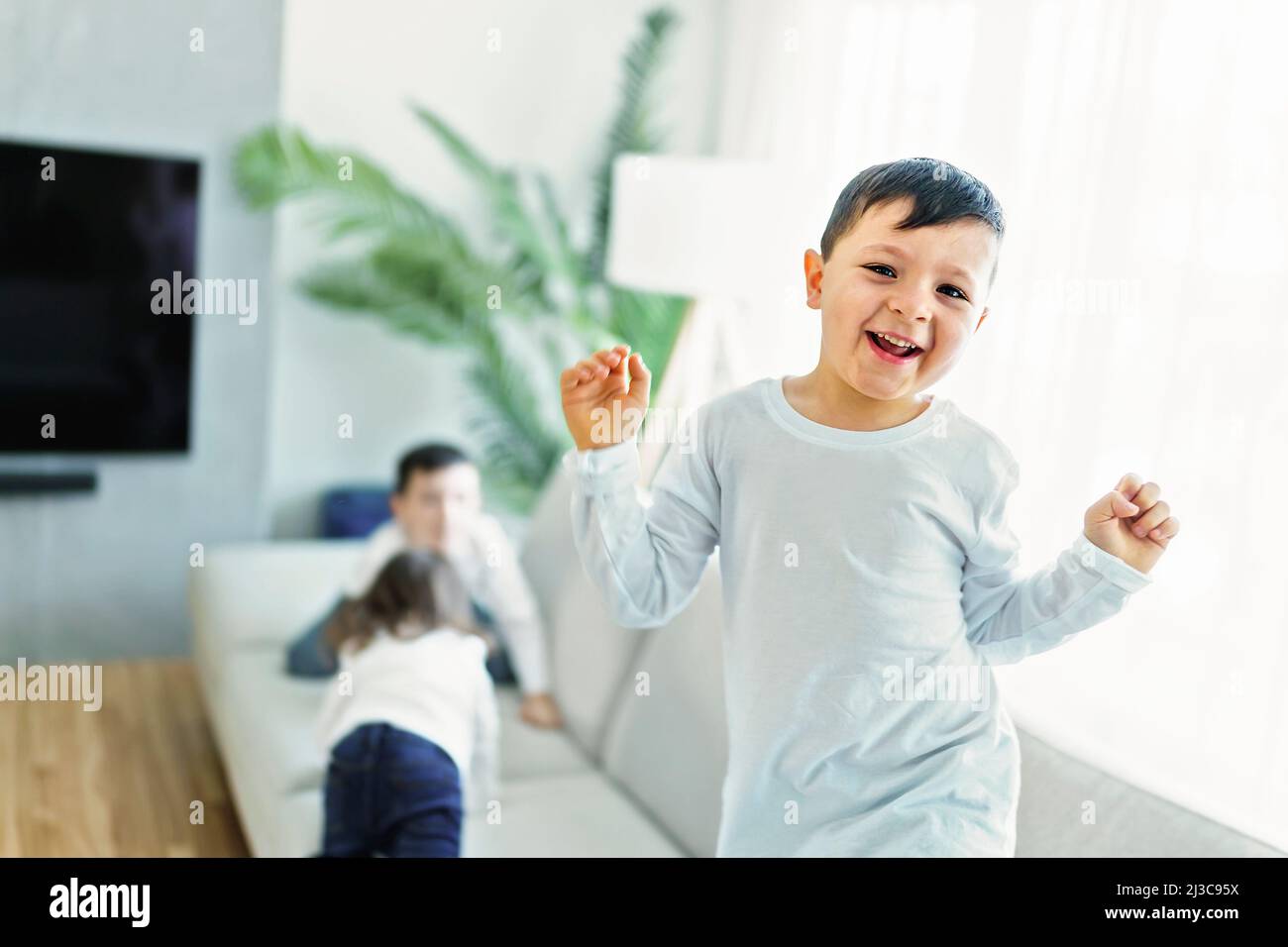 Little crazy boy on living room look like hyperactive Stock Photo