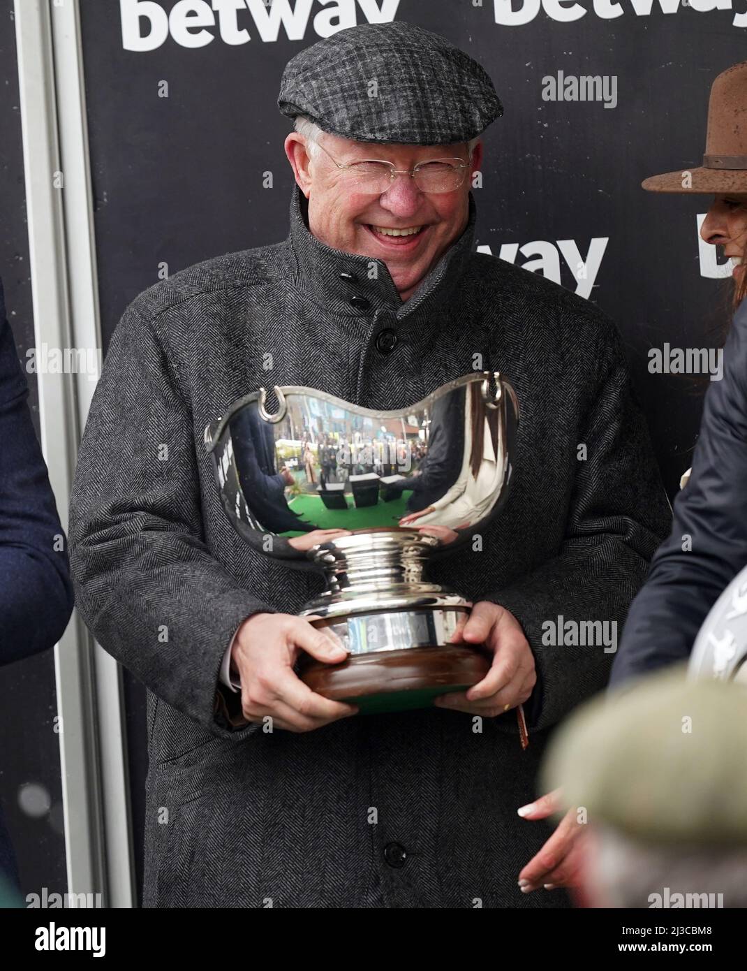 Sir Alex Ferguson celebrates with the Betway Bowl Chase trophy after his horse Clan Des Obeaux ridden by Harry Cobden won the Betway Bowl Chase at Aintree Racecourse, Liverpool. Picture date: Thursday April 7, 2022. Stock Photo