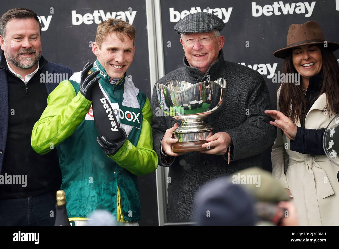 Sir Alex Ferguson celebrates with the Betway Bowl Chase trophy after his horse Clan Des Obeaux ridden by Harry Cobden (left) won the Betway Bowl Chase at Aintree Racecourse, Liverpool. Picture date: Thursday April 7, 2022. Stock Photo
