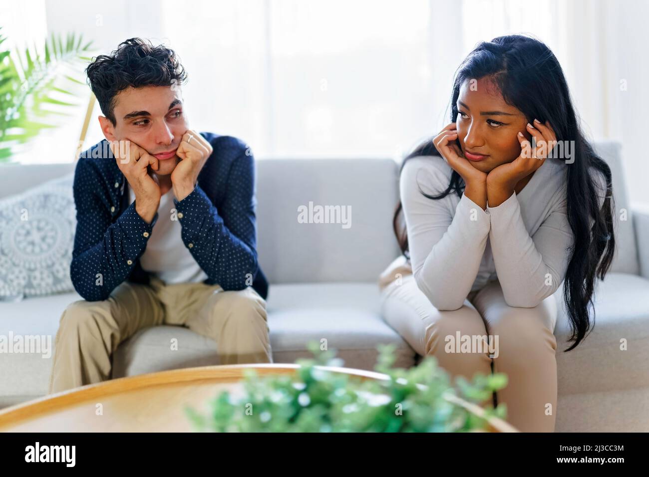 Man being mad at his girlfriend in their living room Stock Photo