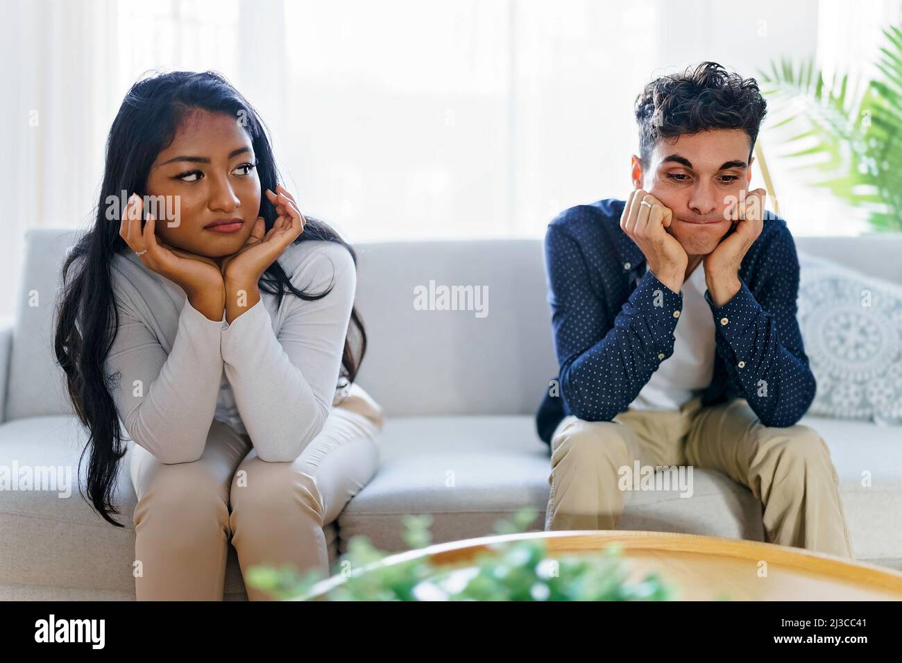 Man being mad at his girlfriend in their living room Stock Photo