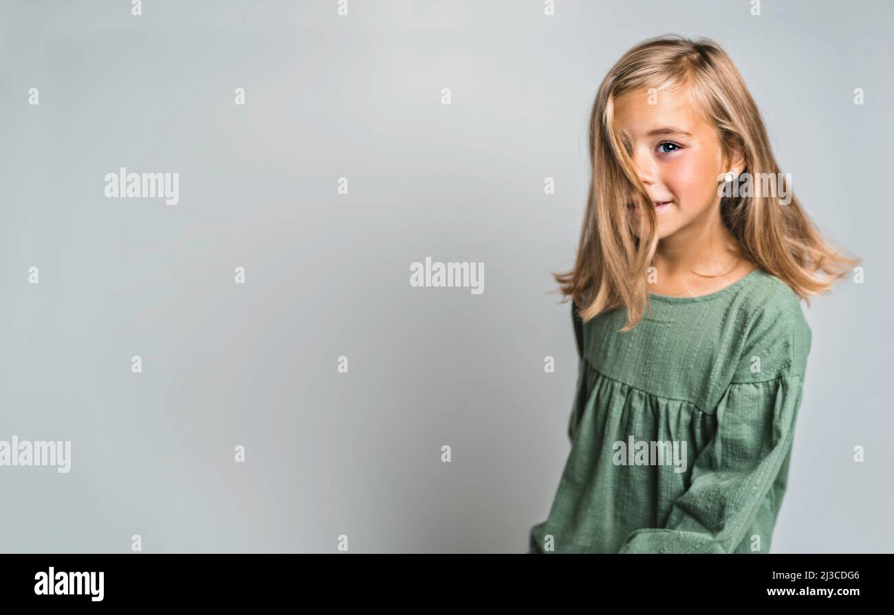 Little child smiling and looking at camera on studio Stock Photo - Alamy