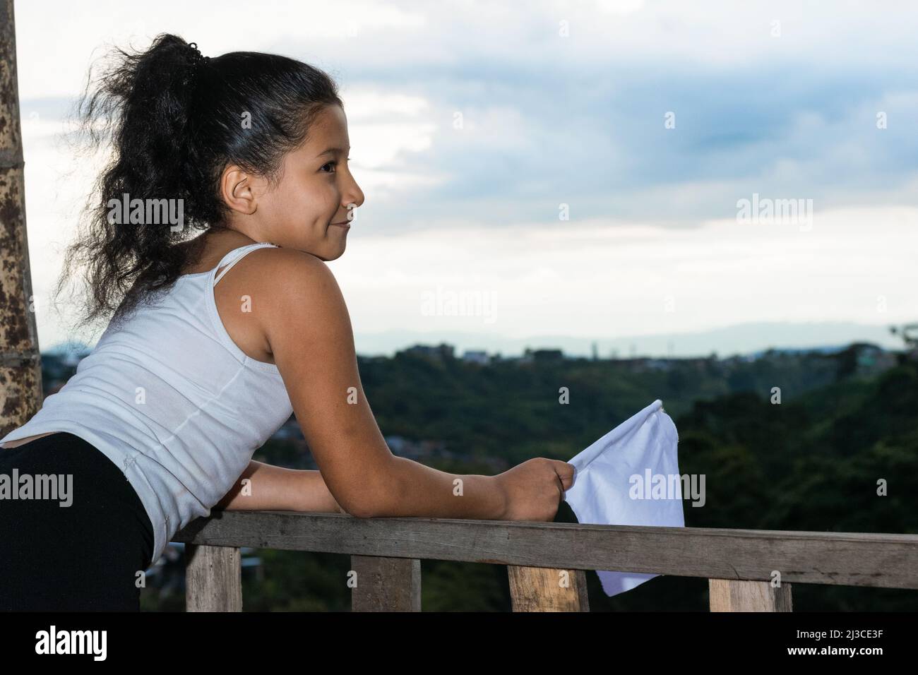beautiful latina girl, brunette with a happy face waving her white flag, happy that the conflict is over and there will be no more massacres. girl cel Stock Photo