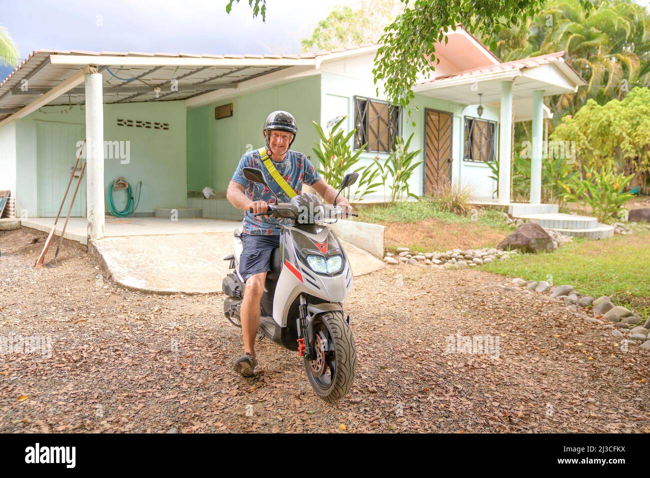Smiling man on scooter hi-res stock photography and images - Alamy