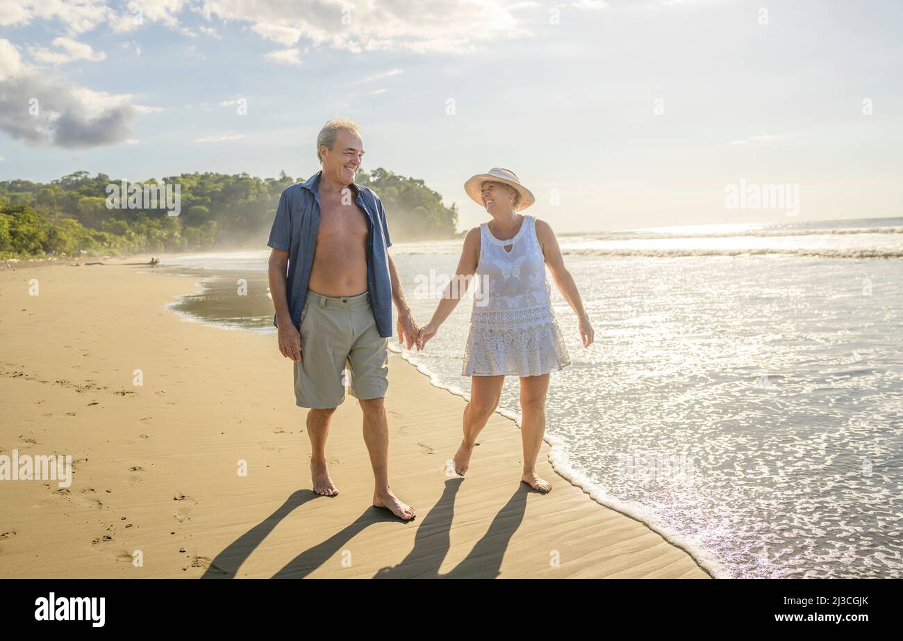 Senior Couple Enjoying Beautiful Sunset on the Beach Stock Photo - Alamy