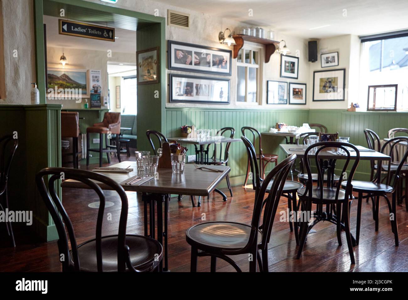 empty tables in the cobblers bar at the wyatt hotel westport county mayo republic of ireland Stock Photo