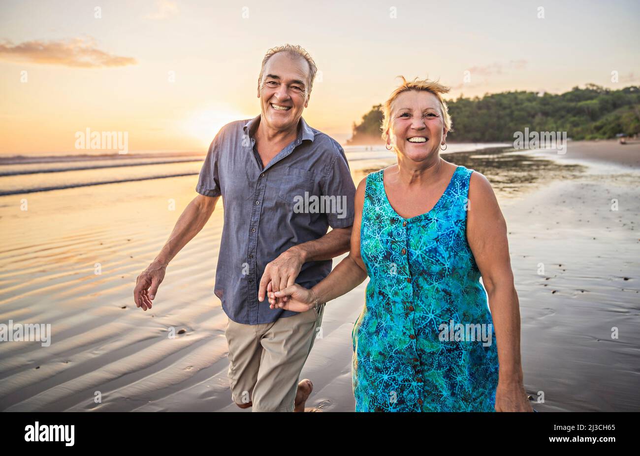 Senior Couple Enjoying Beautiful Sunset on the Beach Stock Photo - Alamy