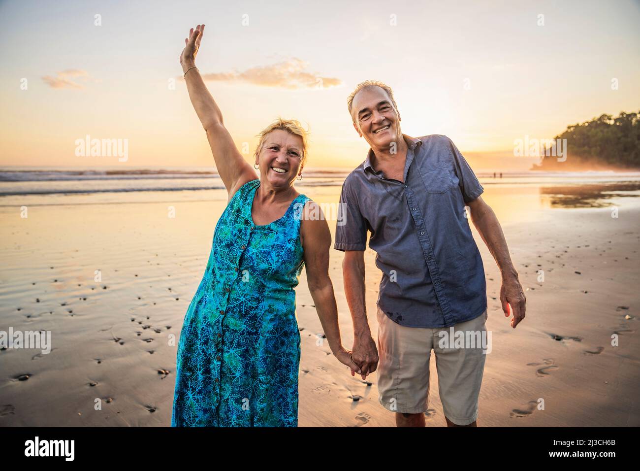 Senior Couple Enjoying Beautiful Sunset on the Beach Stock Photo - Alamy