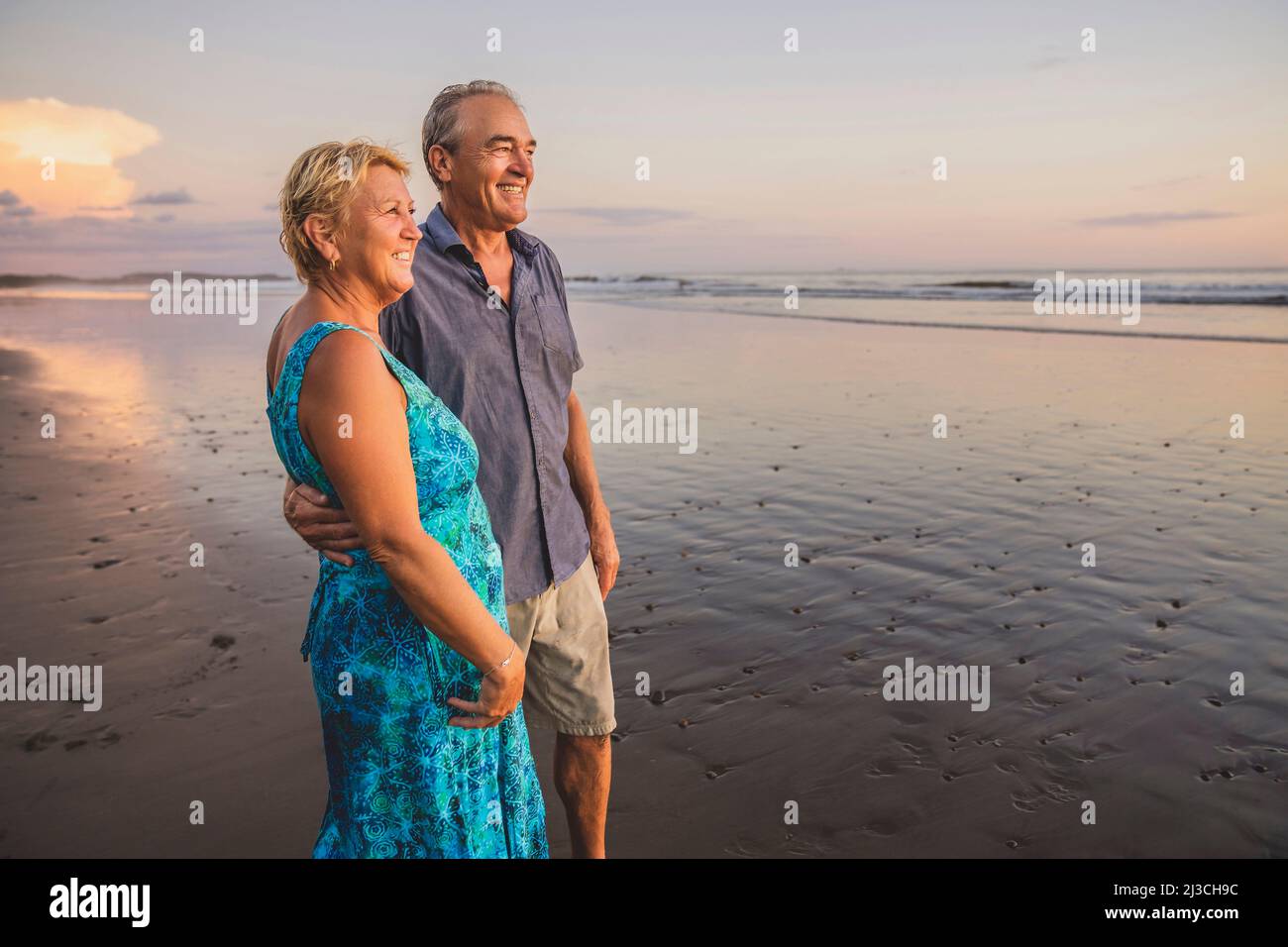 Senior Couple Enjoying Beautiful Sunset on the Beach Stock Photo - Alamy