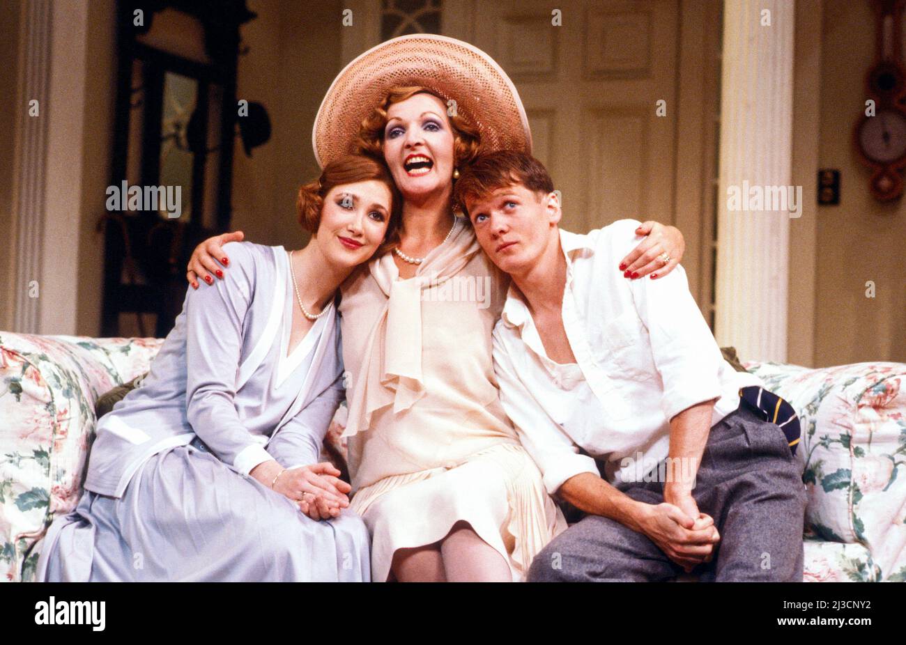 l-r: Rosalyn Landor (Sorel Bliss), Penelope Keith (Judith Bliss), Mark Payton (Simon Bliss) in HAY FEVER by Noel Coward at the Queen’s Theatre, London W1  25/10/1983  design: Carl Toms  lighting: Joe Davis  director: Kim Grant Stock Photo