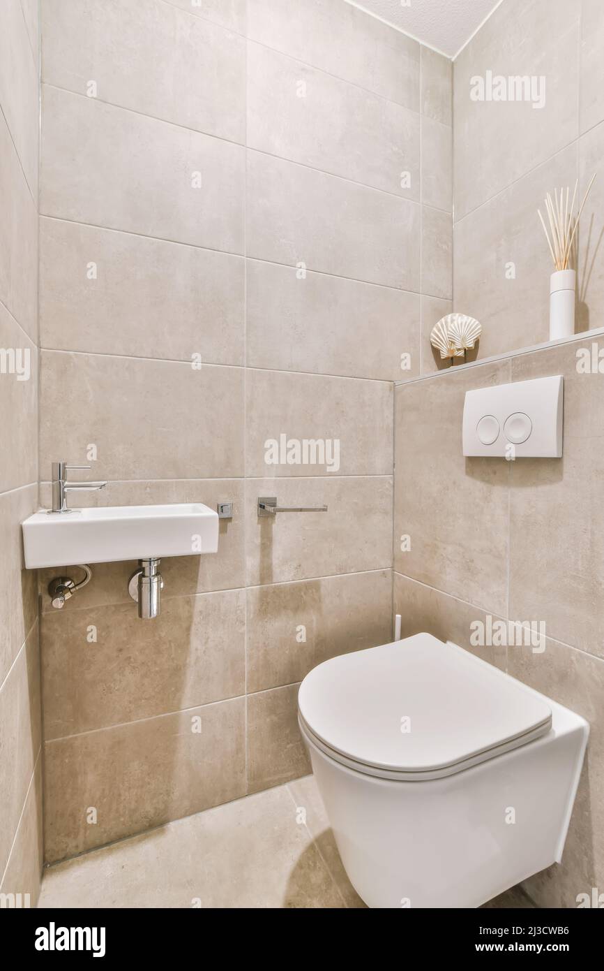 Toilet placed at wall in light small bathroom at home Stock Photo Alamy