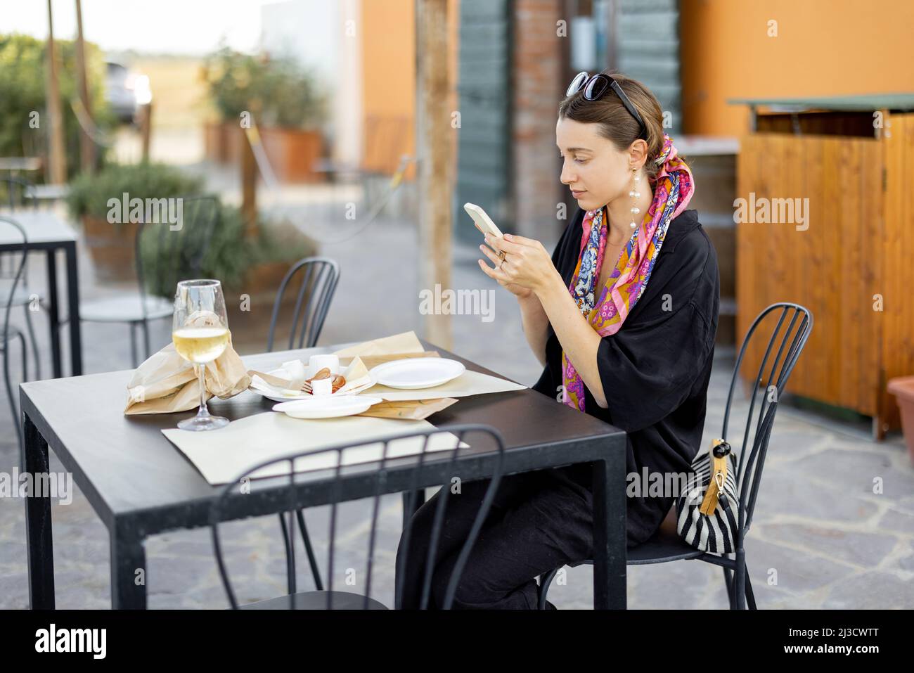 Woman tasting cheese and wine at local farm shop Stock Photo