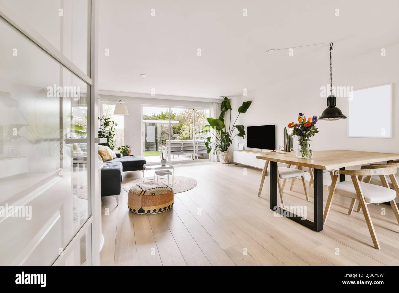 Interior of modern lounge room with white walls and wooden floor
