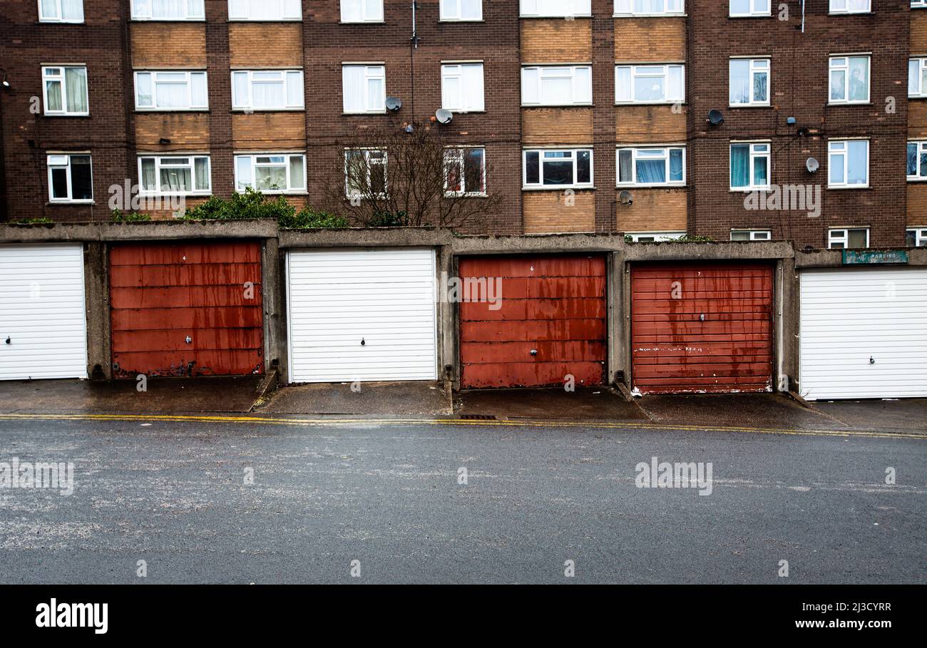 A council estate with with social housing in tower blocks and rows of disused garages in the North of England during the UK Government's levelling up Stock Photo