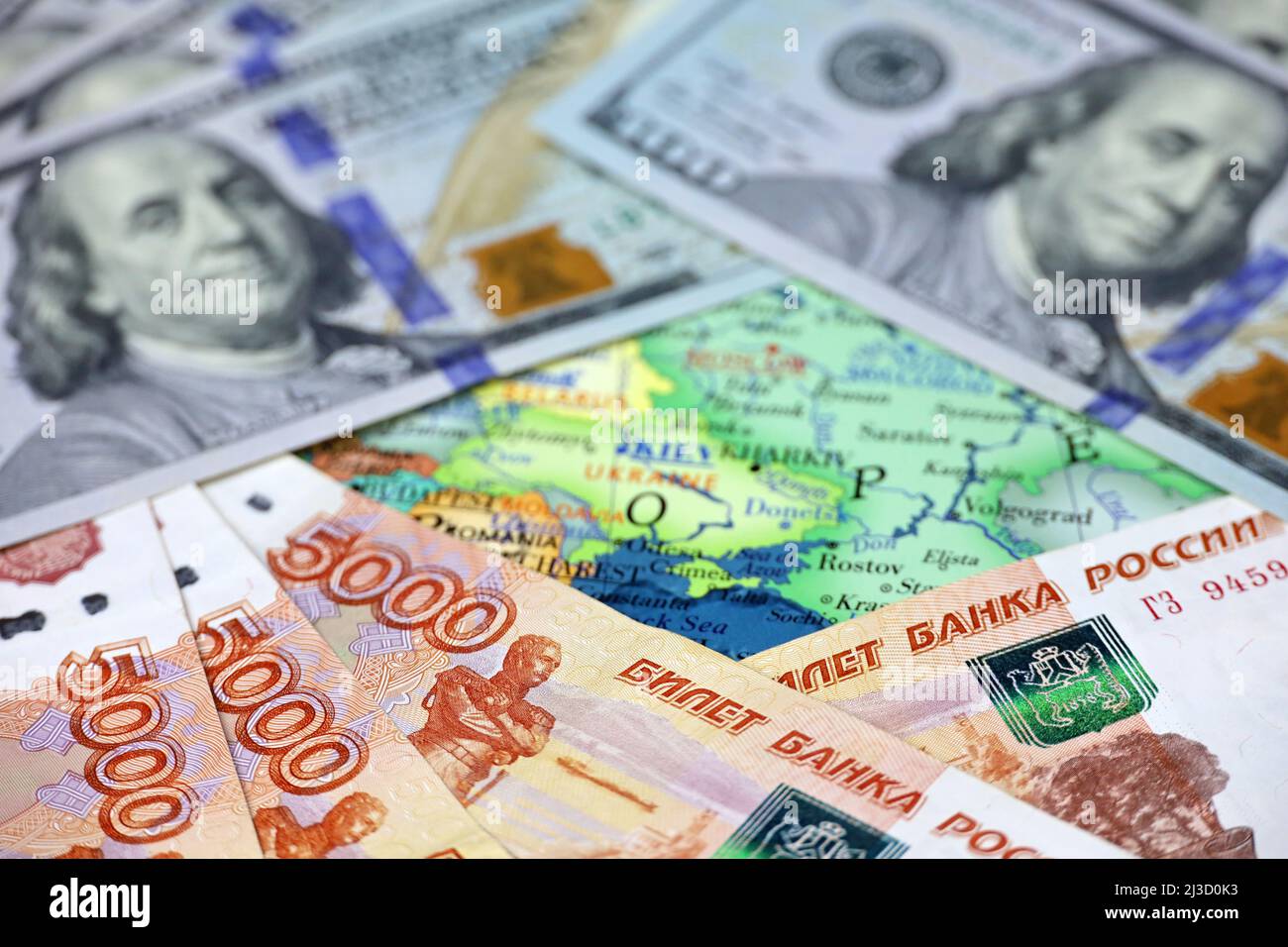 Russian rubles and US dollars on map of Ukraine. Concept of american support for Kiev during special military operation of Russia Stock Photo