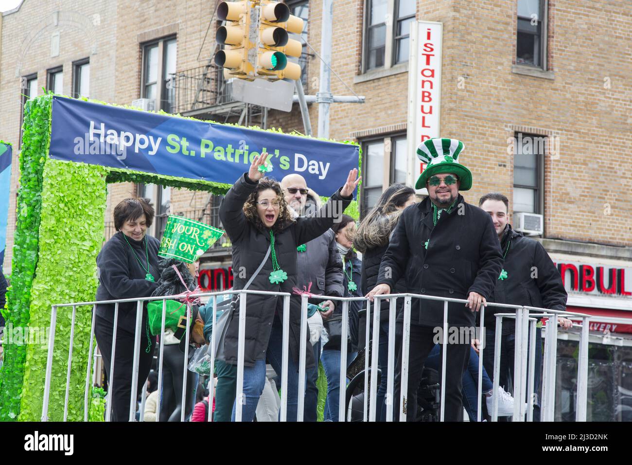 Celebrants at the Saint Patrick's Day Parade ride a float on 3rd Avenue