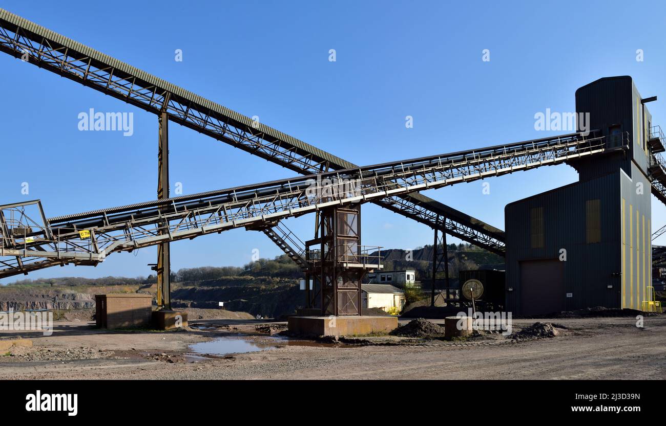 Conveyor belts with stone crushing and sorting buildings in a stone quarry Stock Photo