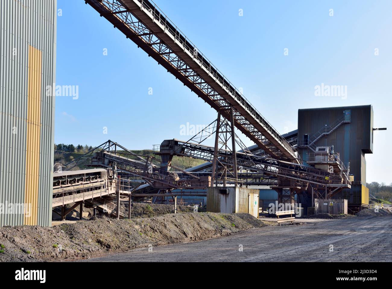 Conveyor belts with stone crushing and sorting buildings in a stone quarry Stock Photo