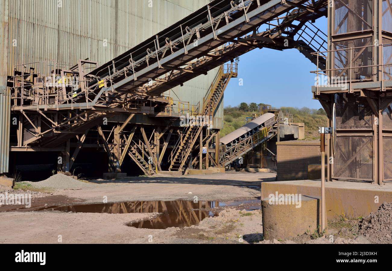 Conveyor belts with stone crushing and sorting buildings in a stone quarry Stock Photo