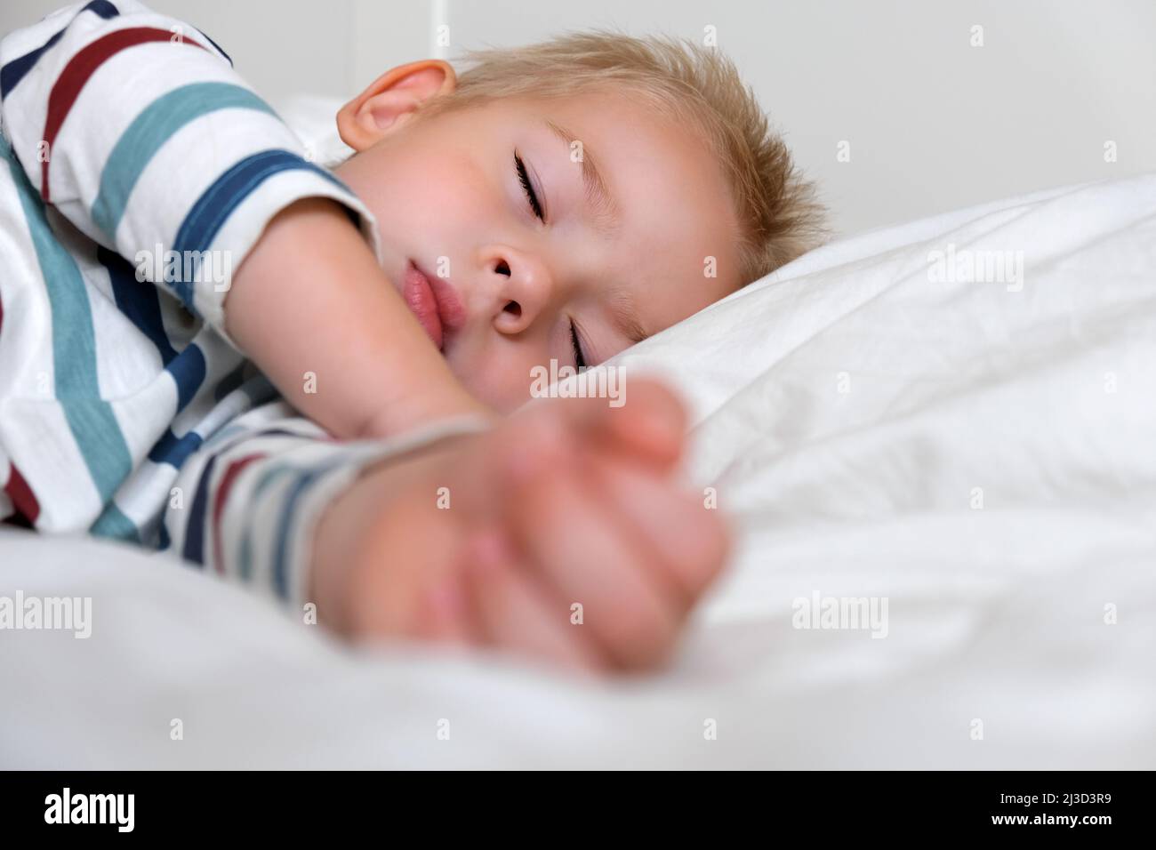 Sleeping Child in Bed. Cute Little Kid Sleeps Sweetly on Cozy White