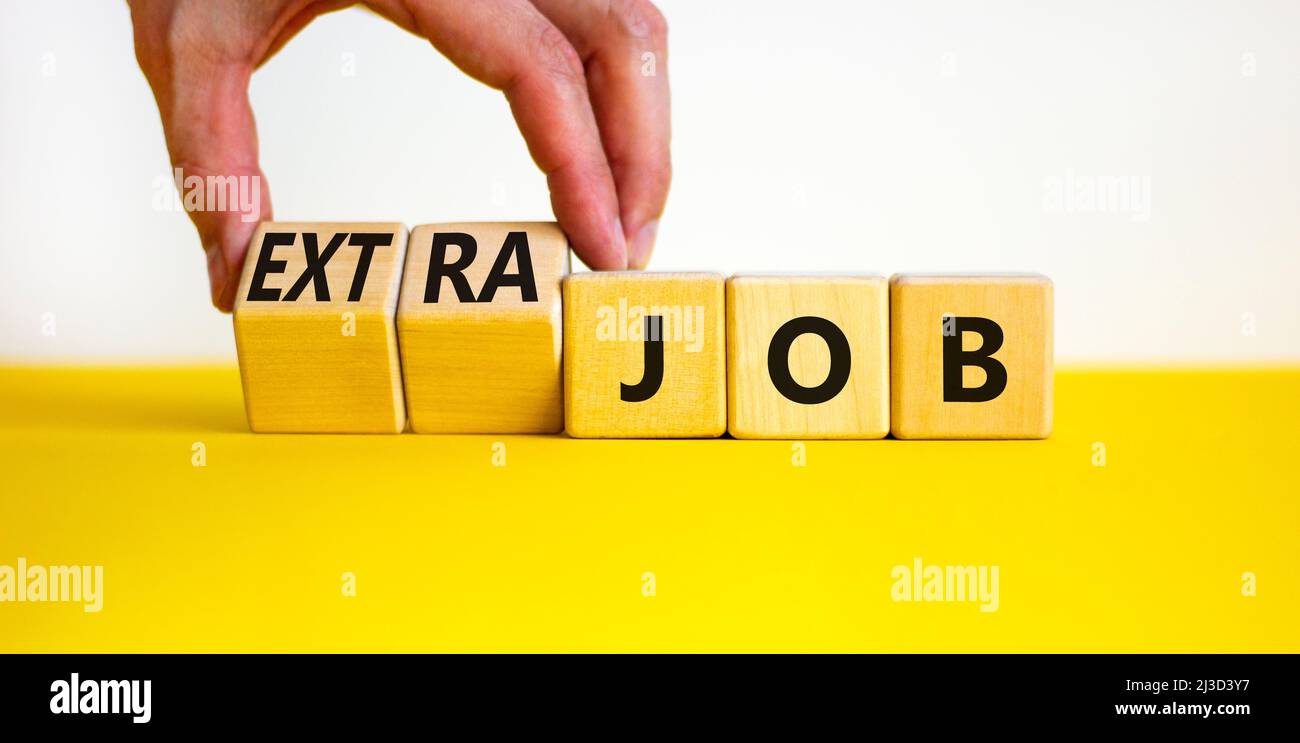 Extra job symbol. Businessman turns wooden cubes and changes concept ...